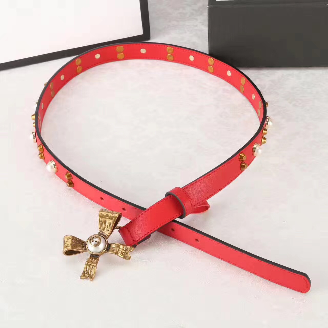 Studded leather belt with metal bow, GUCCI Belts