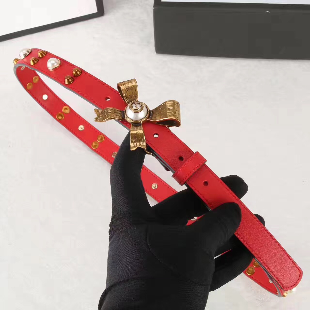 Studded leather belt with metal bow, GUCCI Belts