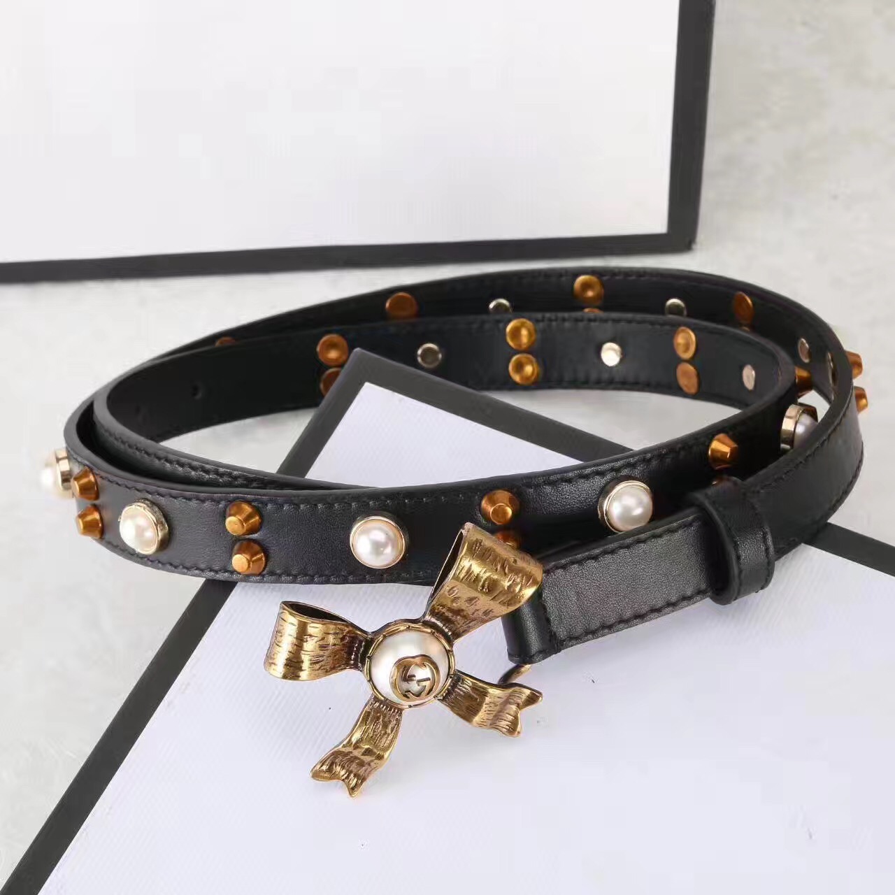 Studded leather belt with metal bow, GUCCI Belts