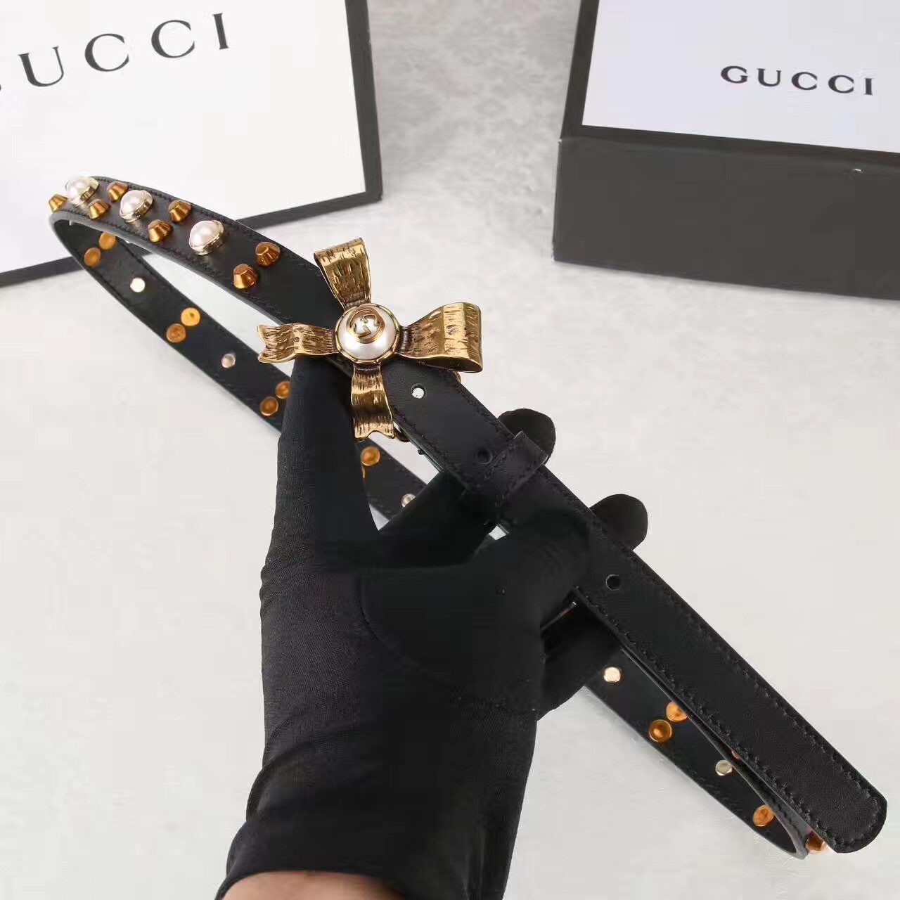 Studded leather belt with metal bow, GUCCI Belts