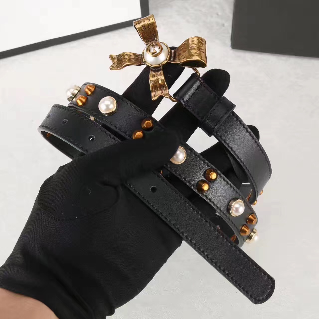 Studded leather belt with metal bow, GUCCI Belts