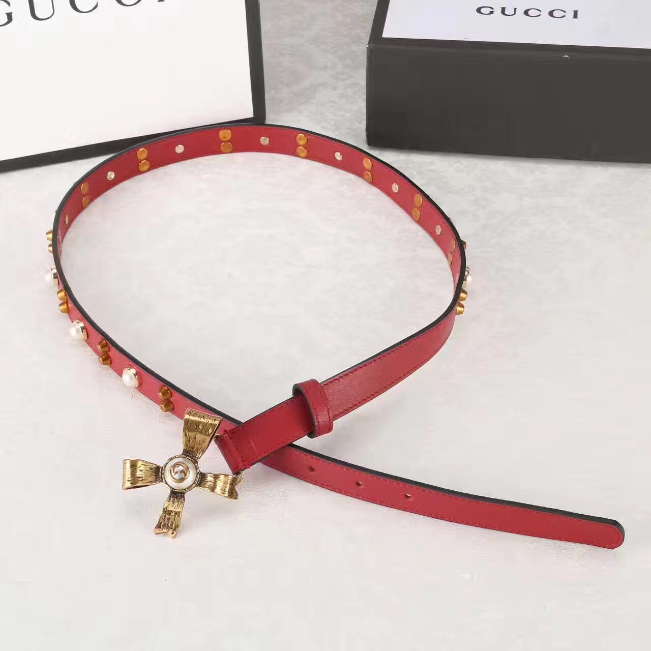 Studded leather belt with metal bow, GUCCI Belts