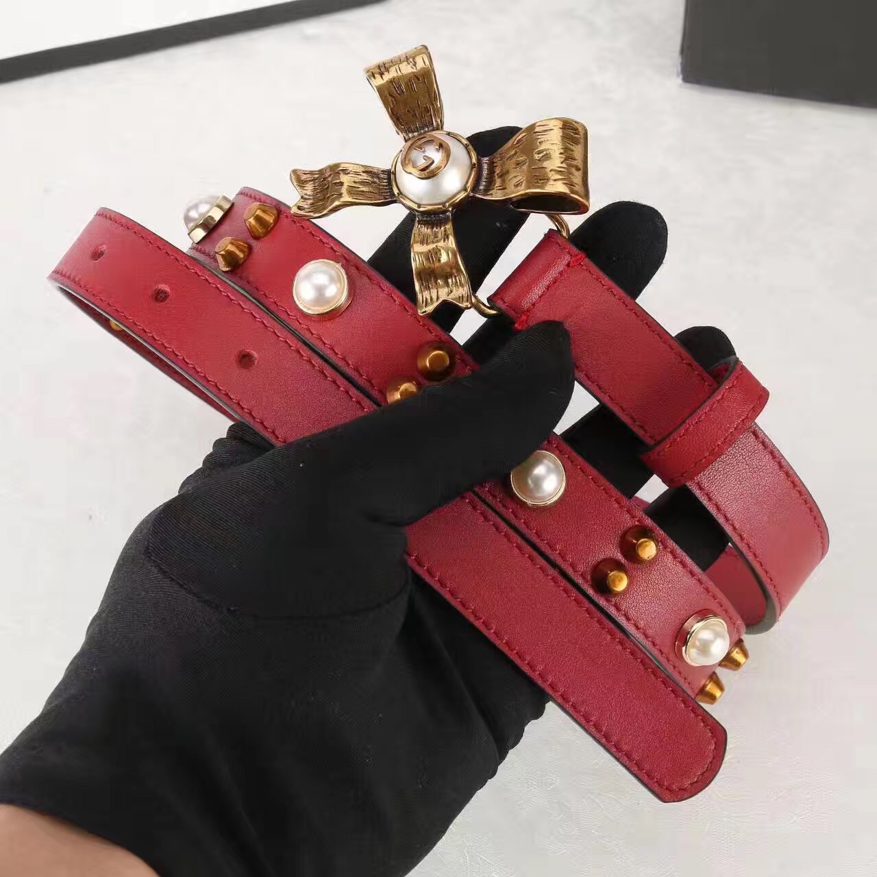 Studded leather belt with metal bow, GUCCI Belts